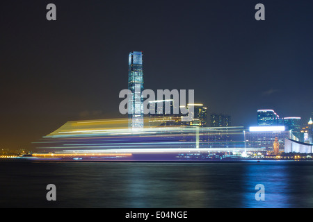 Motion Blur Of A Ship Passing in the Night, Victoria Harbour, Hong Kong. Stock Photo