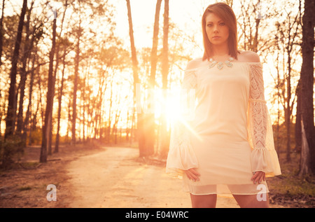 Young woman in white dress at sunrise Stock Photo