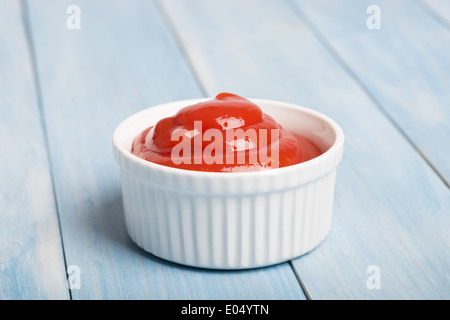 Portion of tomato sauce in a white ceramic dish Stock Photo