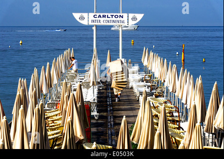 Europe, France, Alpes-Maritimes, Cannes. Beach attendant at Carlton Palace Hotel. Stock Photo