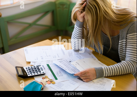 A woman with open calculations has many debts. Unemployment and private bankruptcy, Eine Frau mit offenen Rechnungen hat viele S Stock Photo