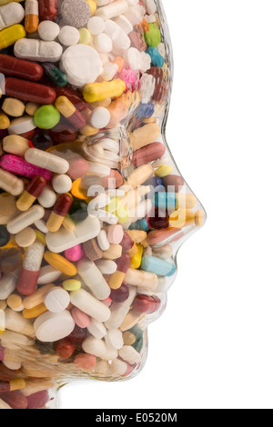 A head of glass with many tablets full. Symbolic photo for drugs, abuse and tablet addiction., Ein Kopf aus Glas mit vielen Tabl