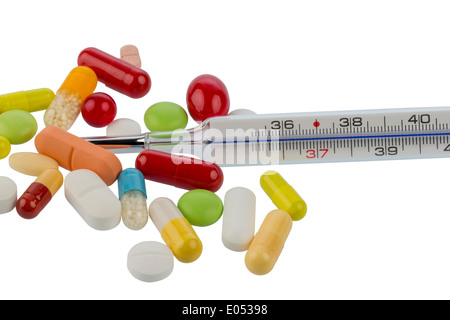 A clinical thermometer and tablets lie on a white background, Ein Fieberthermometer und Tabletten liegen auf einem weissen Hinte Stock Photo