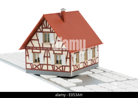 Dwelling house on keyboard, symbolic photo for house purchase and renting on the Internet, Wohnhaus auf Tastatur, Symbolfoto fue Stock Photo