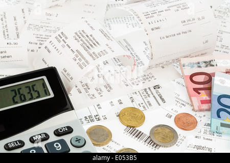 Pocket calculator, receipts and money, symbolic photo for saving, buying power and inflation, Taschenrechner, Kassenbons und Gel Stock Photo