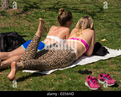 Two Young Woman Sunbathing , Central Park, NYC, USA Stock Photo