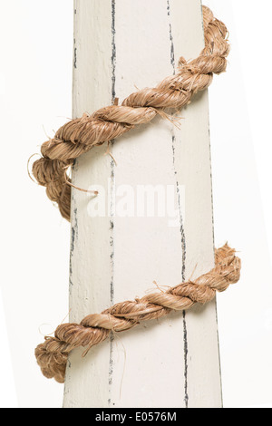 wrapped rope on wood over white background Stock Photo