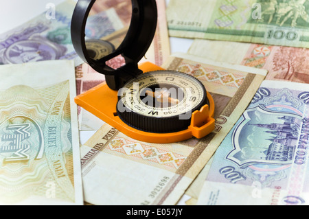 Banknotes and compass. Navigation in the world of Finance. On a white background are old banknotes, is a compass. Stock Photo