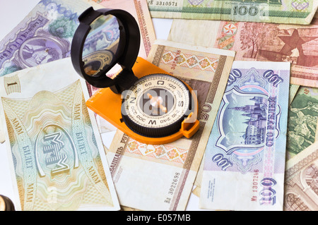 and compass. Navigation in the world of Finance. On a white background are old banknotes, is a compass. Stock Photo