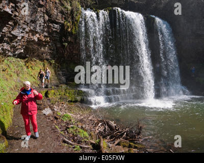 Walking behind the popular Sgwd yr Eira waterfall in Brecon Beacons National Park waterfalls country Stock Photo