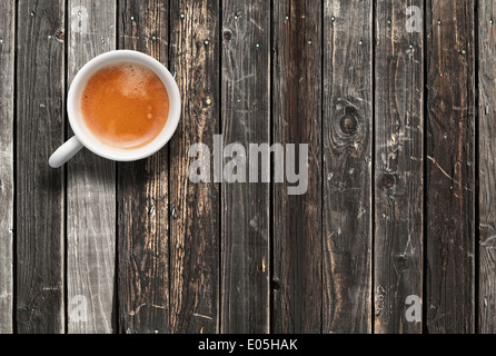 White coffee cup, top view on dark wooden table background Stock Photo