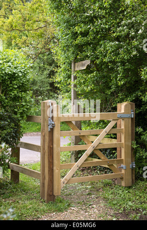 Small five bar wooden gate on footpath route in English countryside Stock Photo