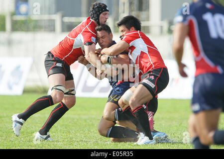 Justin Coveney of the Philippines (C) is tackled by Japan's defense during their Rugby World Cup qualifying match in Silangan, Laguna on May 3, 2014.  Japan won against the Philippines, 99-10.(Photo by Mark Fredesjed R. Cristino / Pacific Press) Stock Photo