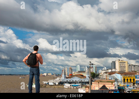 Tourist watching the cityscape by the Amazon River dominated by the Fish Market, Belem, Para State, Brazil Stock Photo