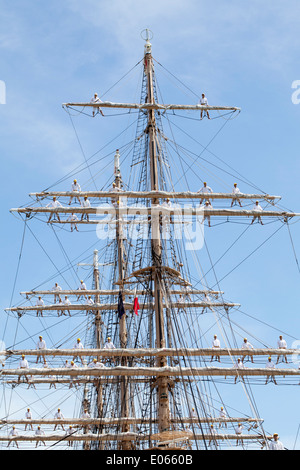 Big sailing ship and sailor men docked at the port Stock Photo