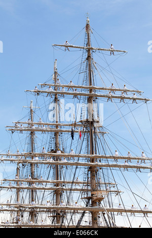Big sailing ship and sailor men docked at the port Stock Photo