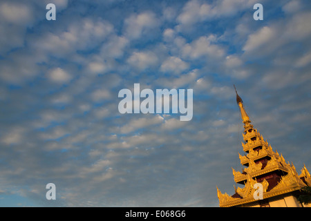 Sutaungpyei Pagoda on Mandalay Hill and overview of the city at sunset, Mandalay, Myanmar Stock Photo