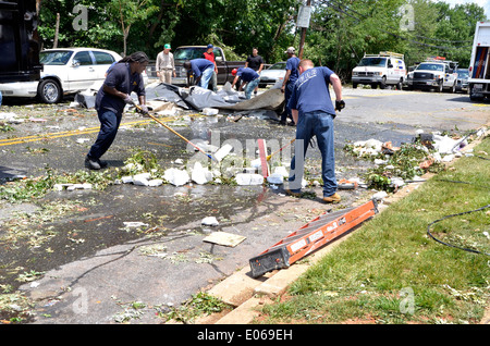 Workers clean up after a severe storm hit causing major damage in ...