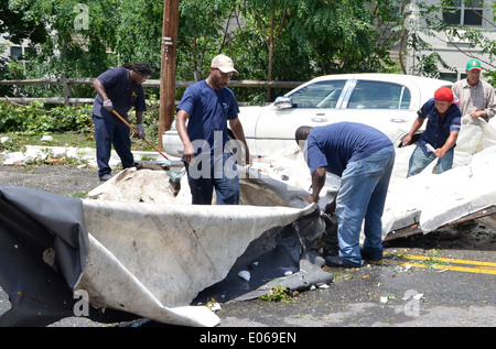 Workers clean up after a severe storm hit causing major damage in ...