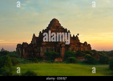 Tourist hot air balloon with ancient temple and pagoda in the jungle at sunrise, Bagan, Myanmar Stock Photo