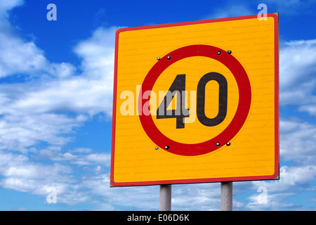 Speed limit road sign above blue cloudy sky Stock Photo