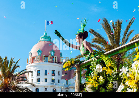 Europe, France, Alpes-Maritimes, Nice. Carnival. Flower parade. Young mannequin waving to the crowd in front of Negresco. Stock Photo