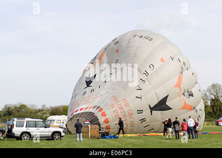 Hot air balloon being inflated before flight across countryside Stock Photo