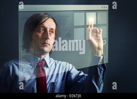 Businessman in blue shirt pressing a digital touch screen button interface Stock Photo