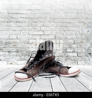 Sneakers in vintage room. Symbol of urban youth lifestyle. Stock Photo