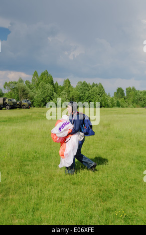 One day with parachutist in airfield.After landing. Stock Photo