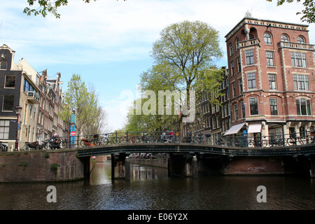 Bridge and old buildings at the crossing of Leliegracht and Herengracht canal in Amsterdam Stock Photo