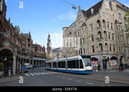 Tram riding through Raadhuisstraat Amsterdam  between Nieuwezijds Voorburgwal and  Keizersgracht Stock Photo