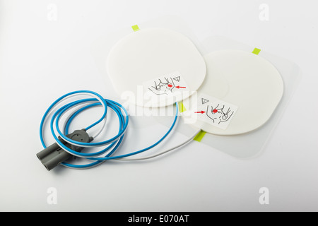 a pair of automatic defibrillator patches on a white table Stock Photo