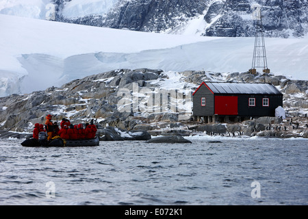 tourist zodiac approaches port lockroy british antarctic heritage trust station on goudier island Antarctica Stock Photo