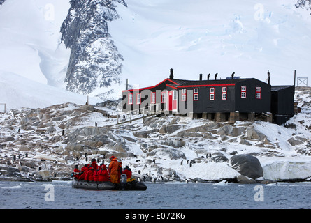 tourist zodiac approaches bransfield house port lockroy british antarctic heritage trust station on goudier island Antarctica Stock Photo