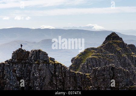 A lone hillwalker on the airy traverse of Liathach in the Torridon area of the Scottish Highlands Stock Photo