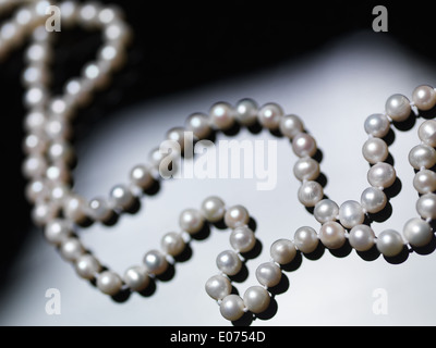 Pearl necklace beads on black and white background Stock Photo