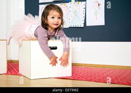 Little girl wears a tutu playing in nursery