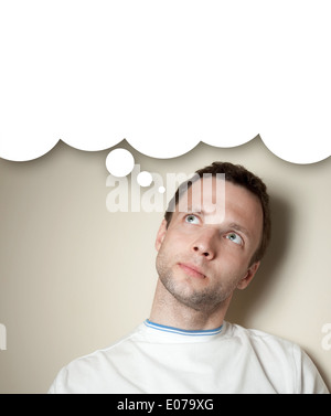 Thinking young Caucasian man with white balloon. Closeup portrait Stock Photo
