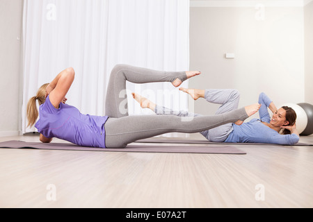 Women doing sit-ups on Pilates class Stock Photo