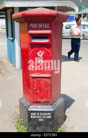 An original 1929 antique red post box - with George V insignia - in a small town outside Kandy, Sri Lanka Stock Photo
