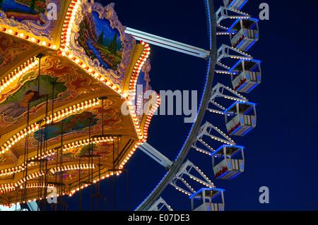 Berlin, Germany. 26th Nov, 2013. An illuminated swing carousel stands in front of a Ferris Wheel on the Christmas market 'Wintertraum ums Alexa' at Alexanderplatz in Berlin, Germany, 26 November 2013. Fotoarchiv für Zeitgeschichte - NO WIRE SERVICE/dpa/Alamy Live News Stock Photo