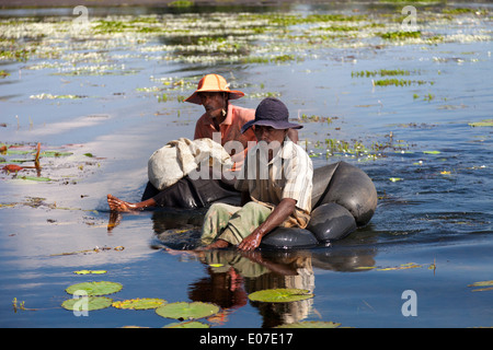 Two unorthodox fishermen paddling in a small lake close to Dambulla, Sri Lanka 6 Stock Photo