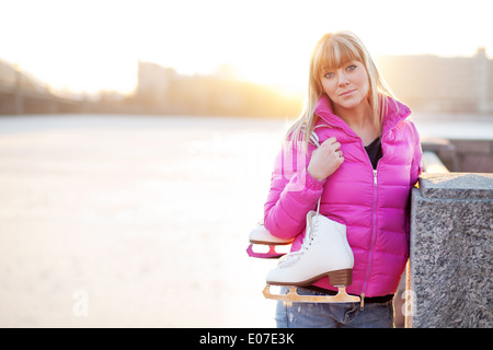 Figure skater woman in city riverfront Stock Photo