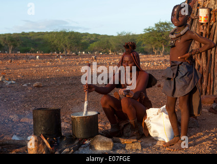 Himba Woman Cooking, Epupa, Namibia Stock Photo