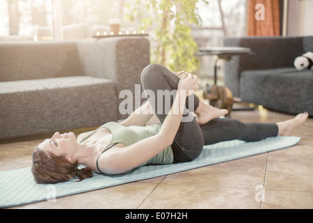 Young woman doing yoga exercise at home Stock Photo