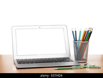 Laptop with blank screen and colorful pencils on wooden table. Isolated on white background Stock Photo