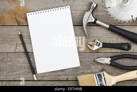 Set of tools on cork panel background with notepad for copy space Stock Photo