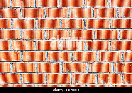 background of wall of red bricks with cement Stock Photo