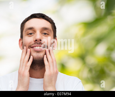 beautiful smiling man touching his face Stock Photo